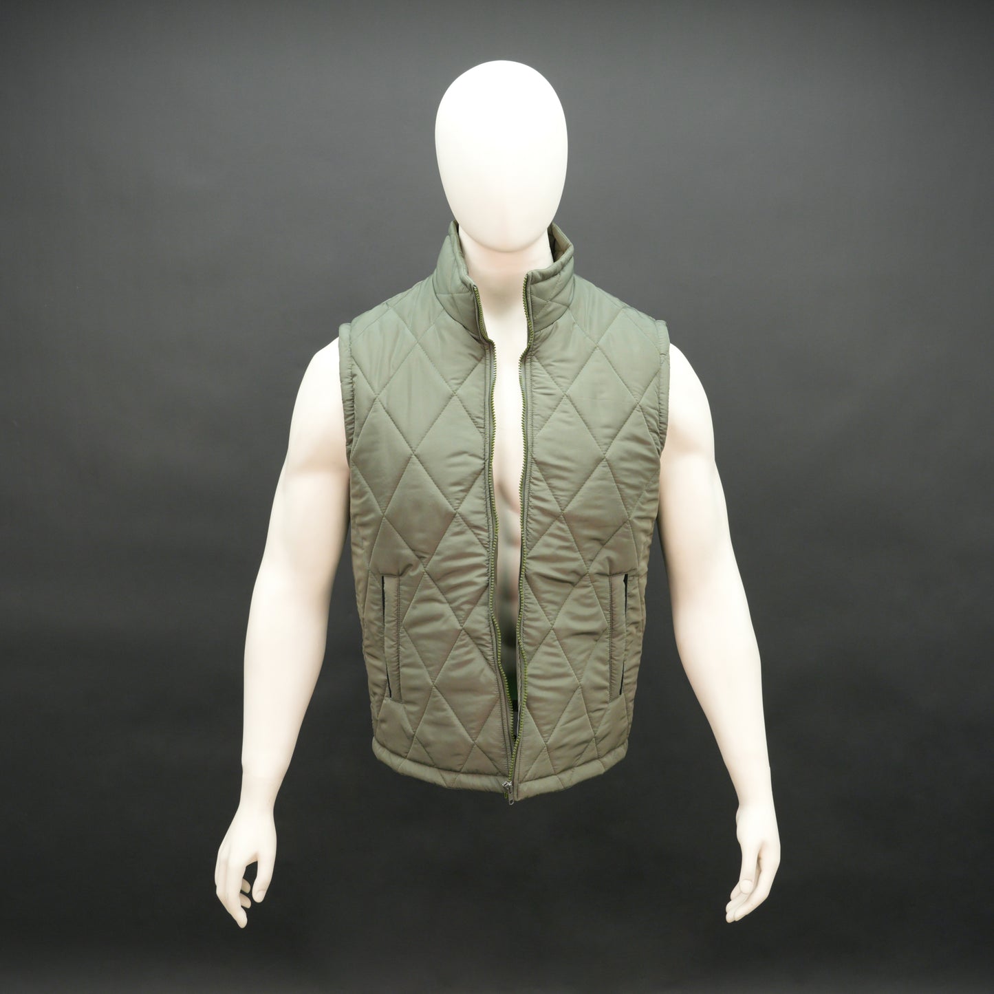 Green sleeveless puffer vest with zip, side and inside pockets, lightweight for layering