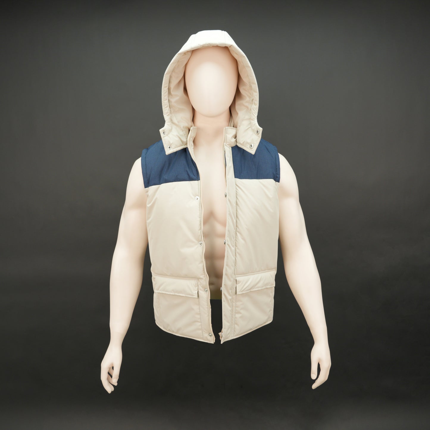Cream-blue two-tone sleeveless puffer jacket with zip and snap closure, hood, side and inner pockets, quilted for layering