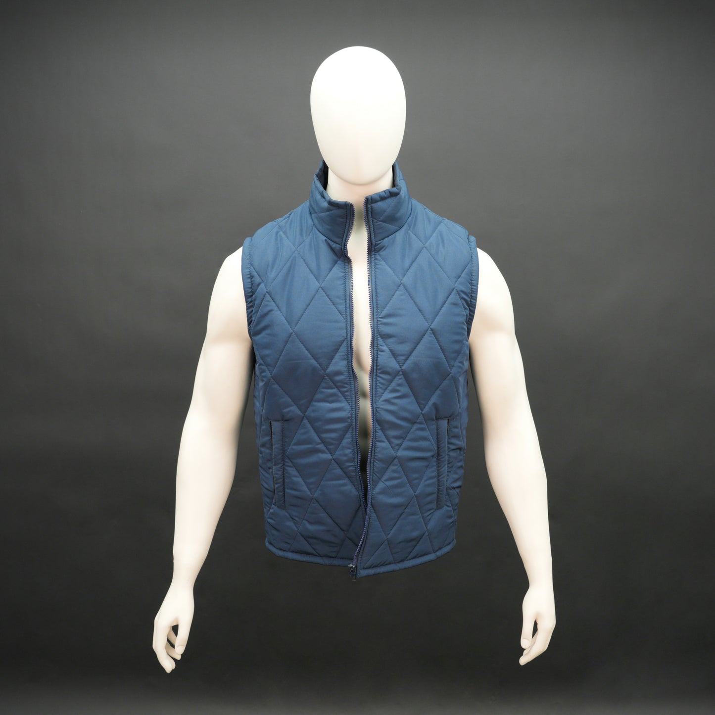 Blue sleeveless puffer vest with zip, side and inside pockets, lightweight for layering