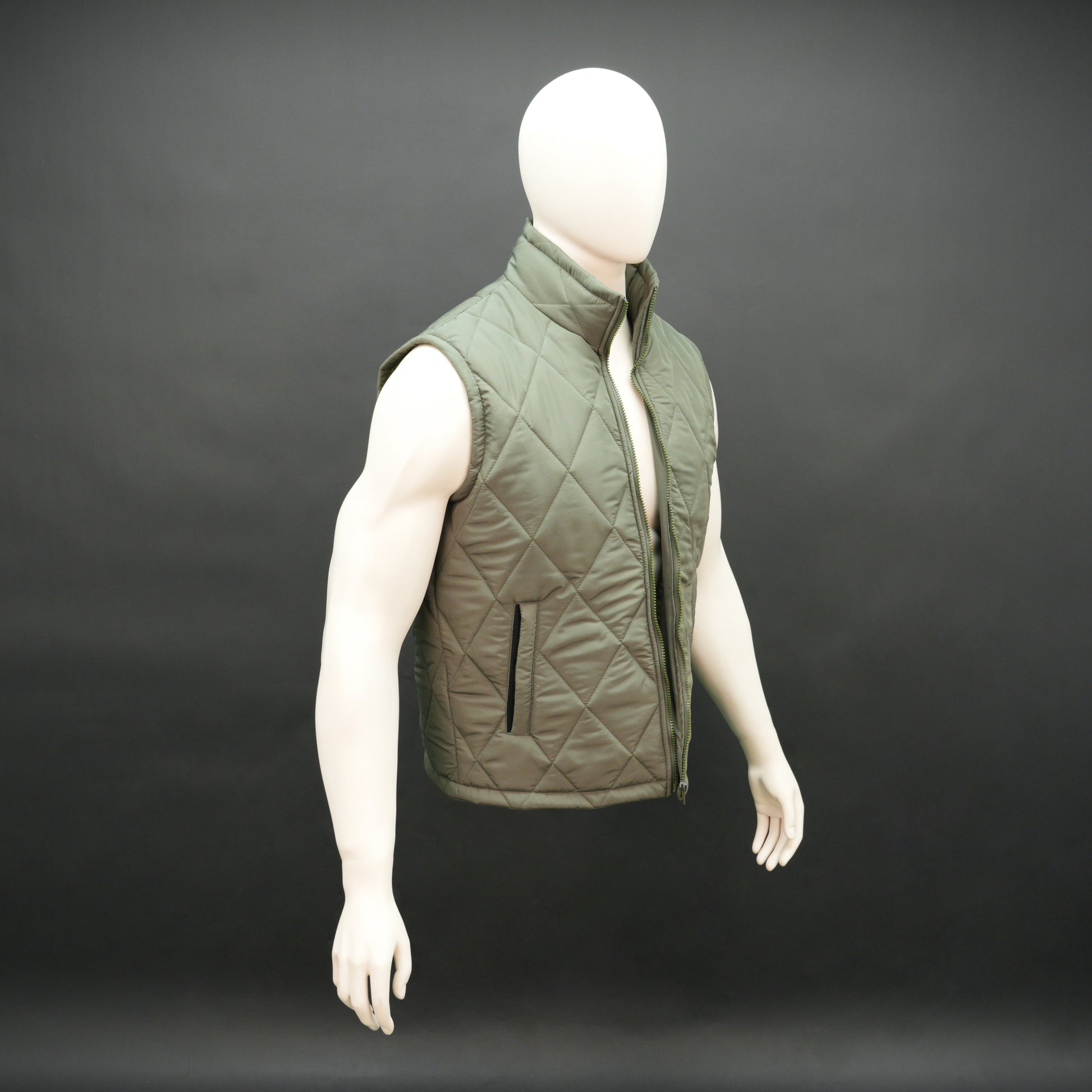 Green sleeveless puffer vest with zip, side and inside pockets, lightweight for layering