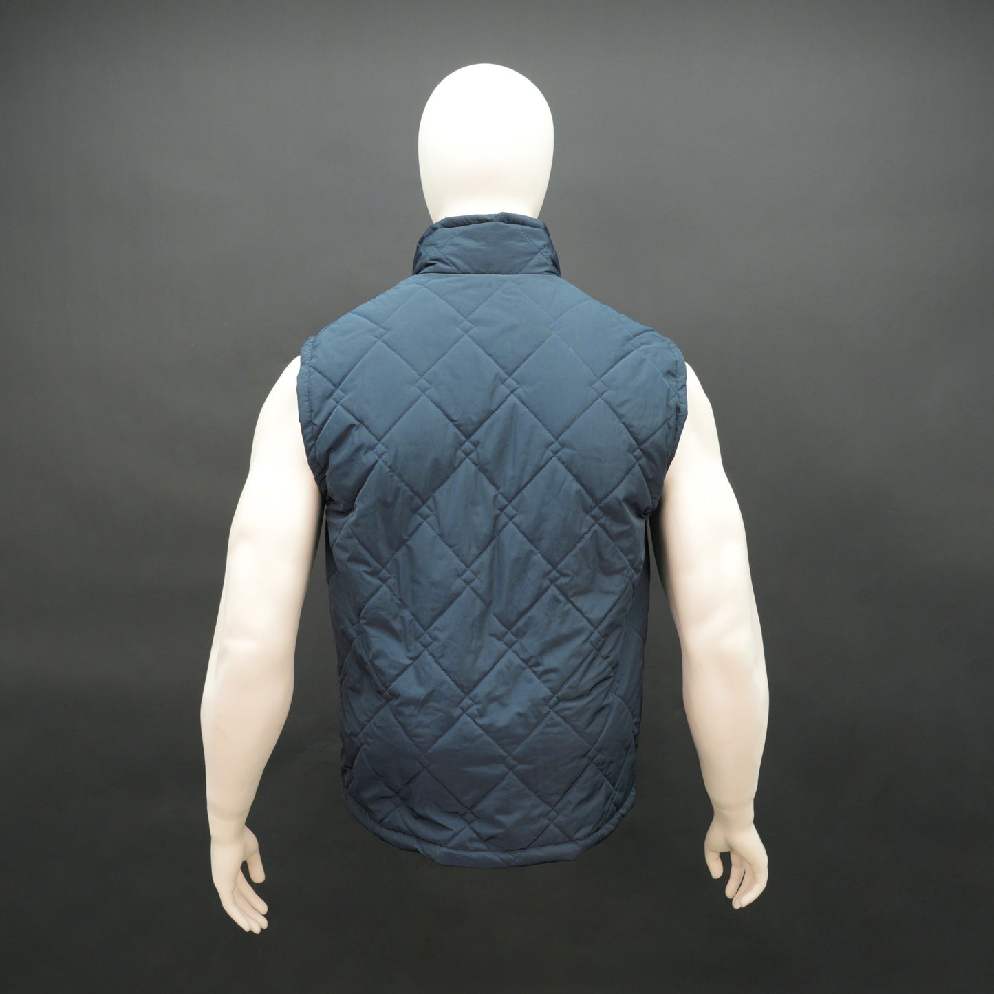 Lightweight navy sleeveless puffer vest with zip closure, side and inside pockets, for layering