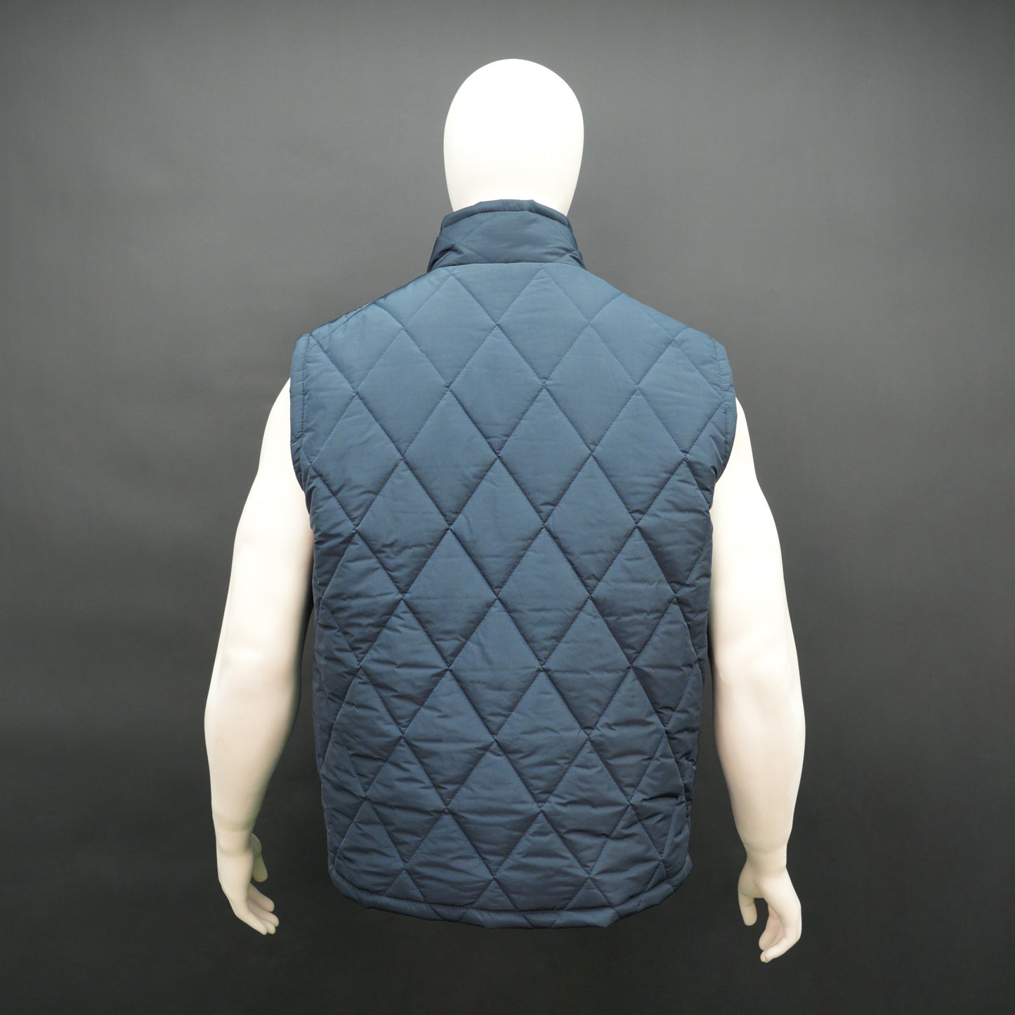 Navy sleeveless puffer vest with zip, side and inside pockets, lightweight for layering