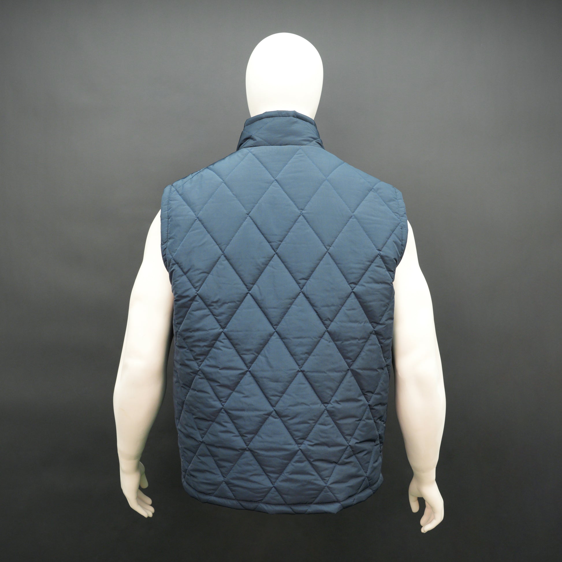Navy sleeveless puffer vest with zip, side and inside pockets, lightweight for layering