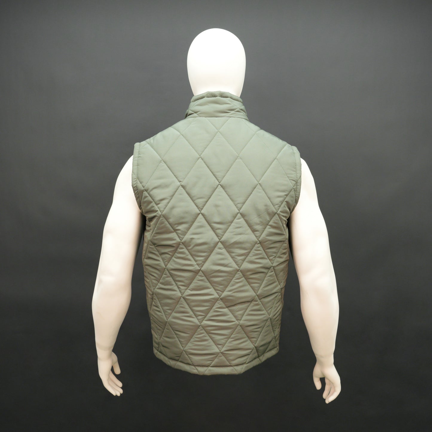 Green sleeveless puffer vest with zip, side and inside pockets, lightweight for layering