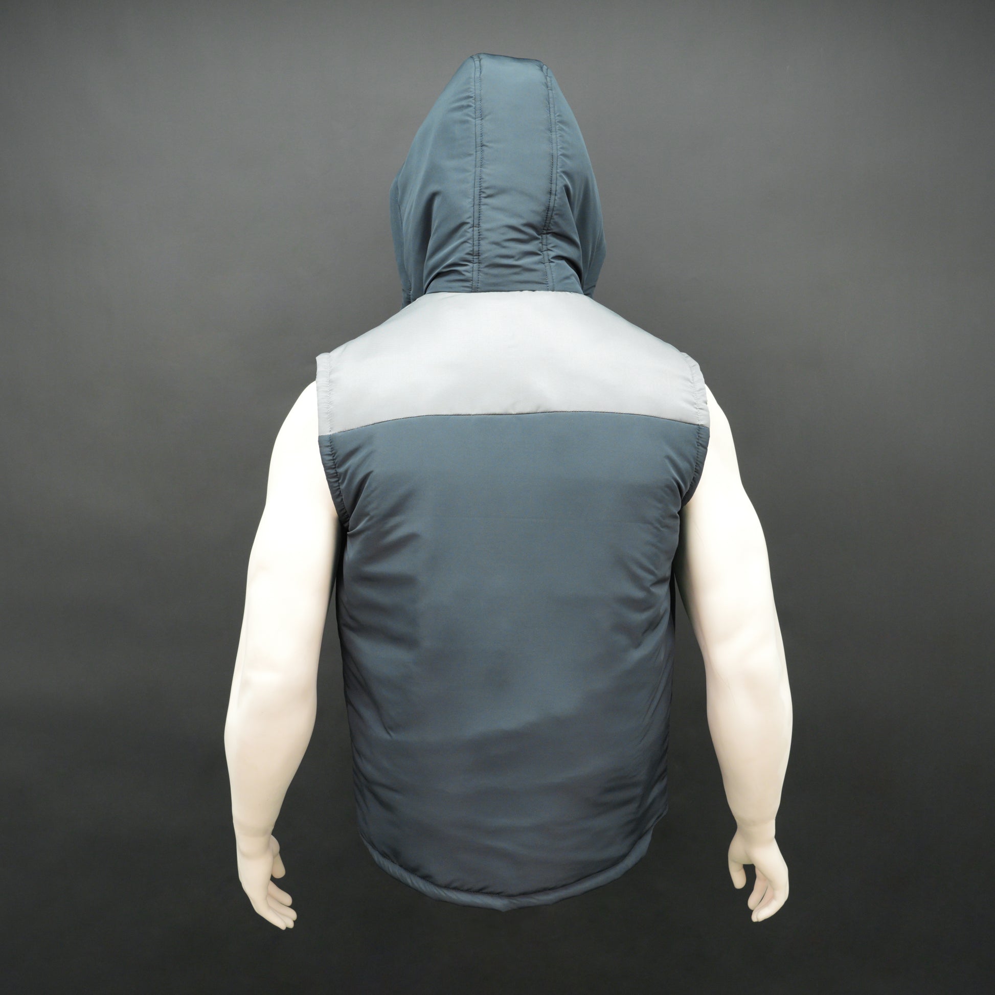 Navy-grey sleeveless puffer jacket with zip and snap closure, hood, side and inner pockets, premium fabric for warmth.