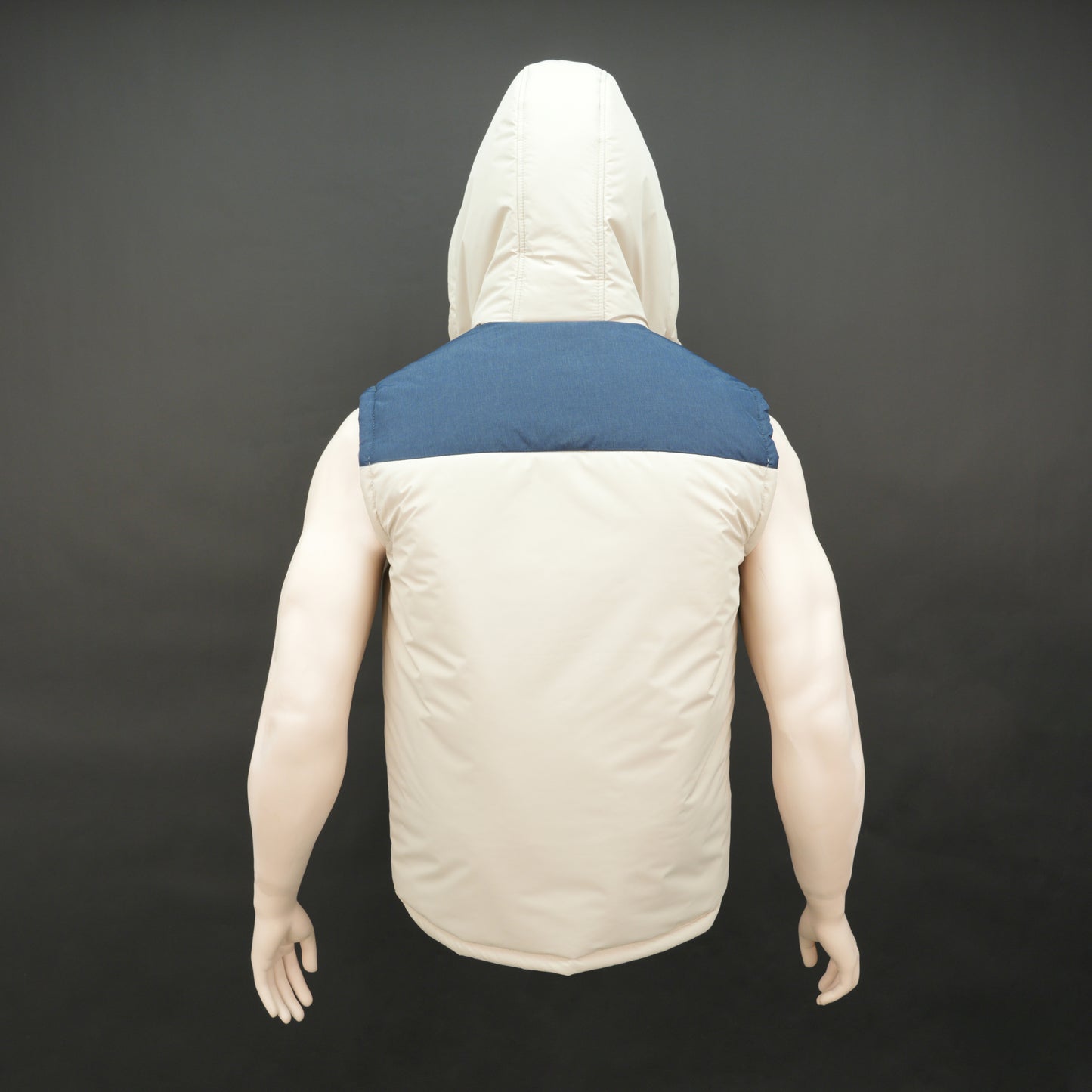 Cream-blue two-tone sleeveless puffer jacket with zip and snap closure, hood, side and inner pockets, quilted for layering