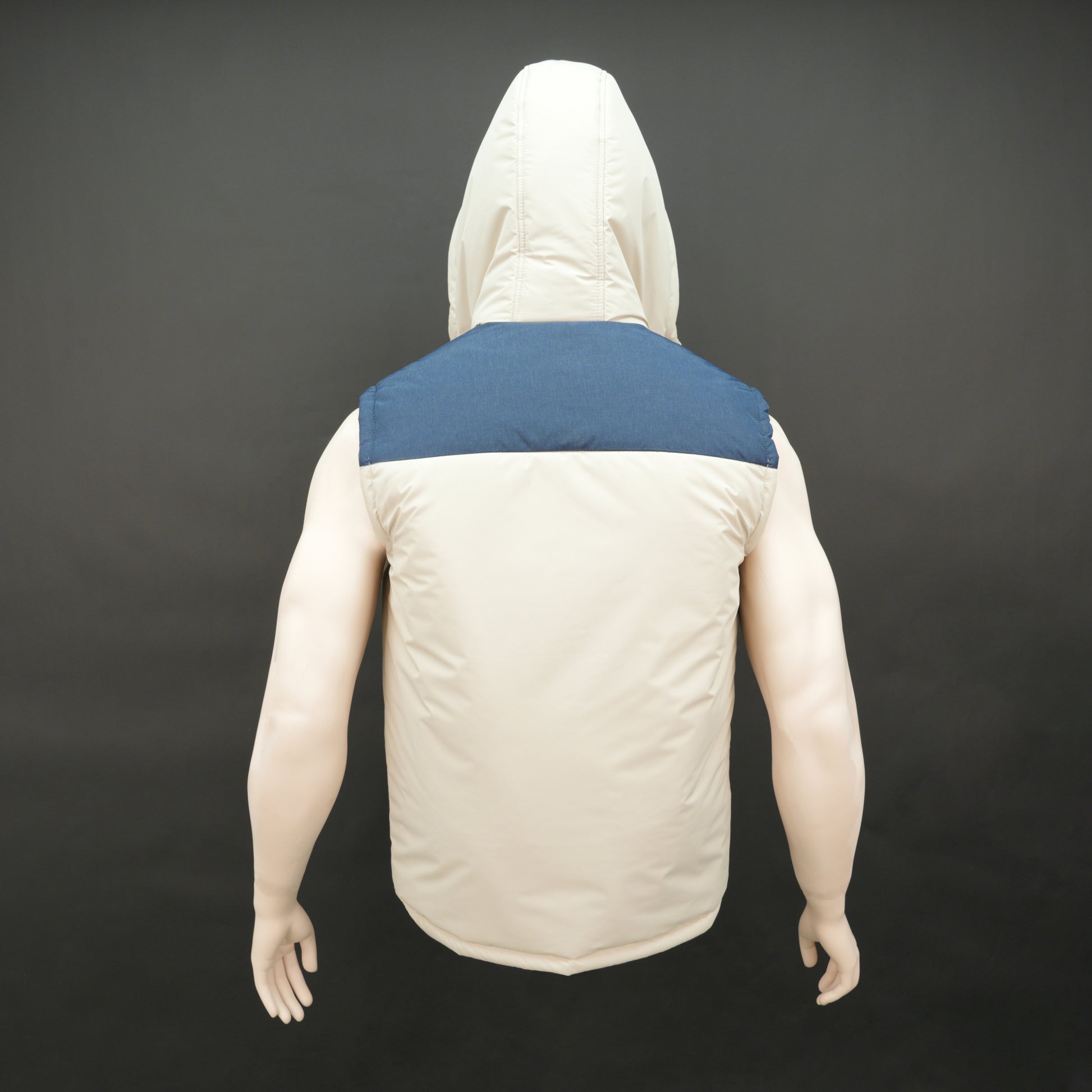 Cream-blue two-tone sleeveless puffer jacket with zip and snap closure, hood, side and inner pockets, quilted for layering