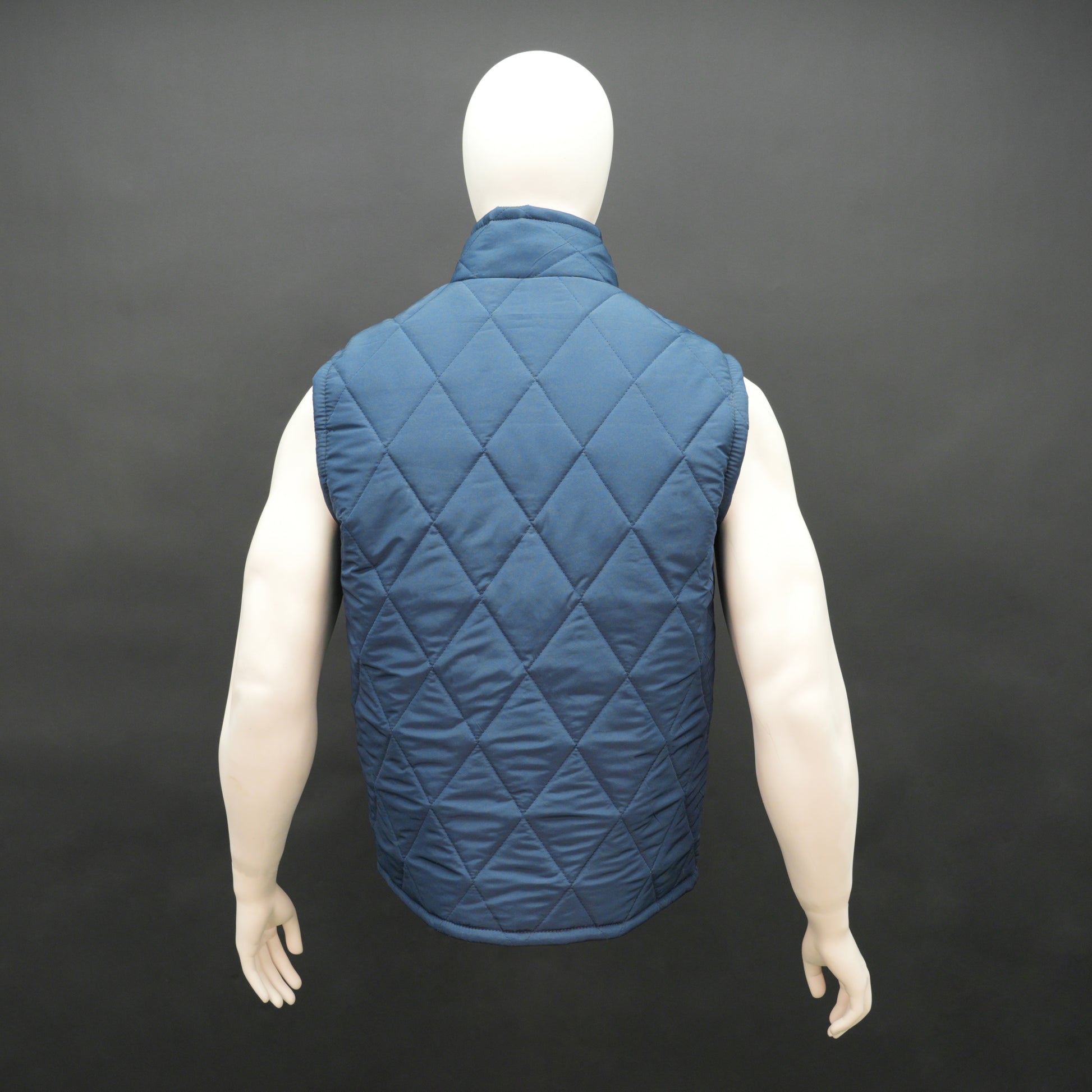 Blue sleeveless puffer vest with zip, side and inside pockets, lightweight for layering