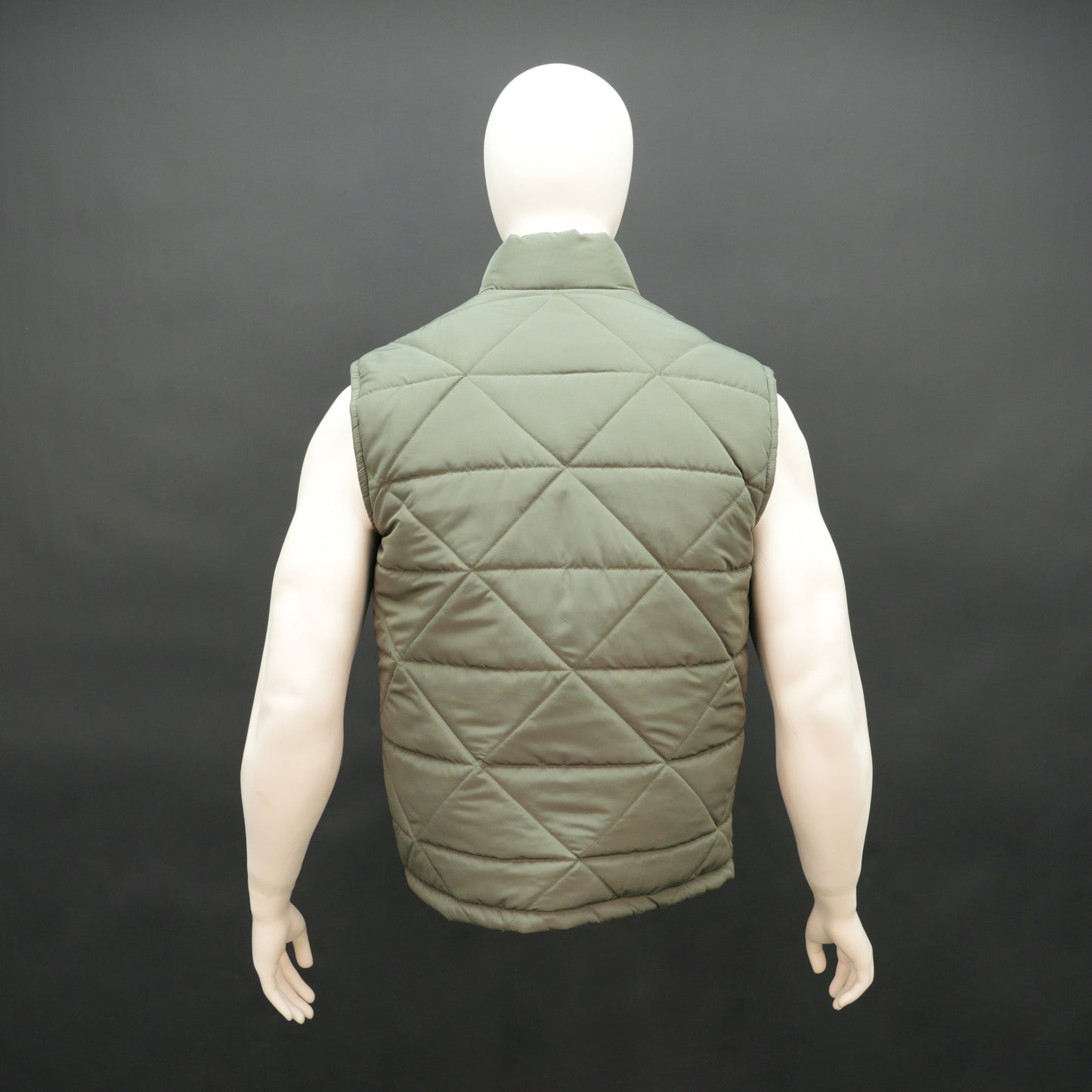 Green sleeveless puffer vest with zip closure, side and inner pockets, lightweight and ideal for layering.