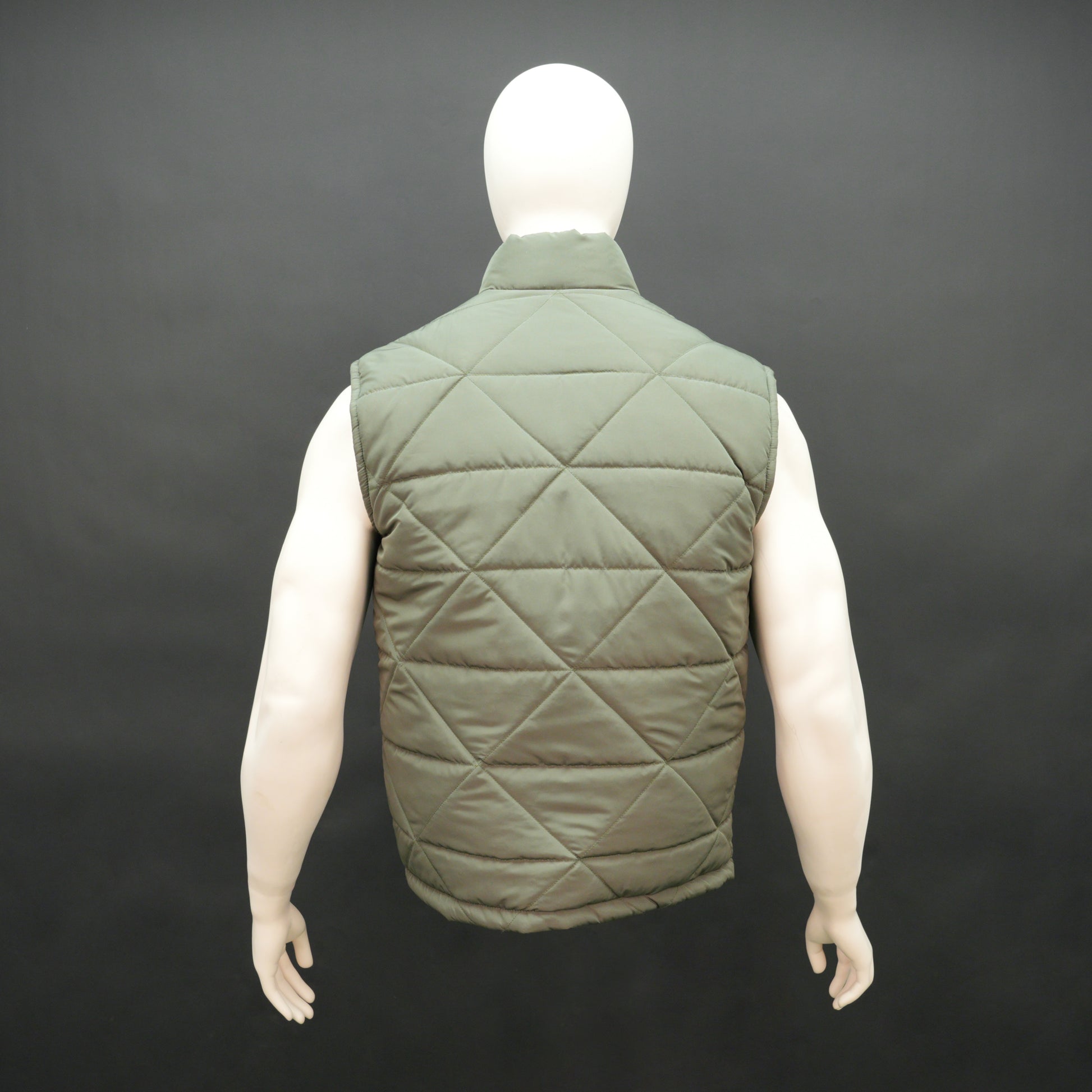 Green sleeveless puffer vest with zip closure, side and inner pockets, lightweight and ideal for layering.