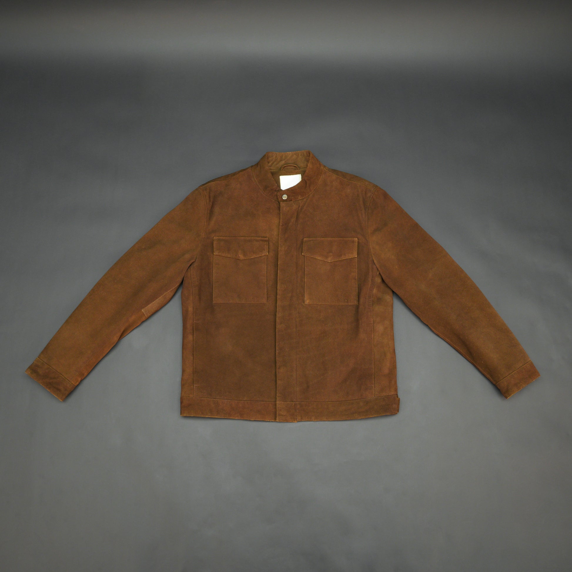 Brown suede leather jacket with front pocket and unique button and zip opening