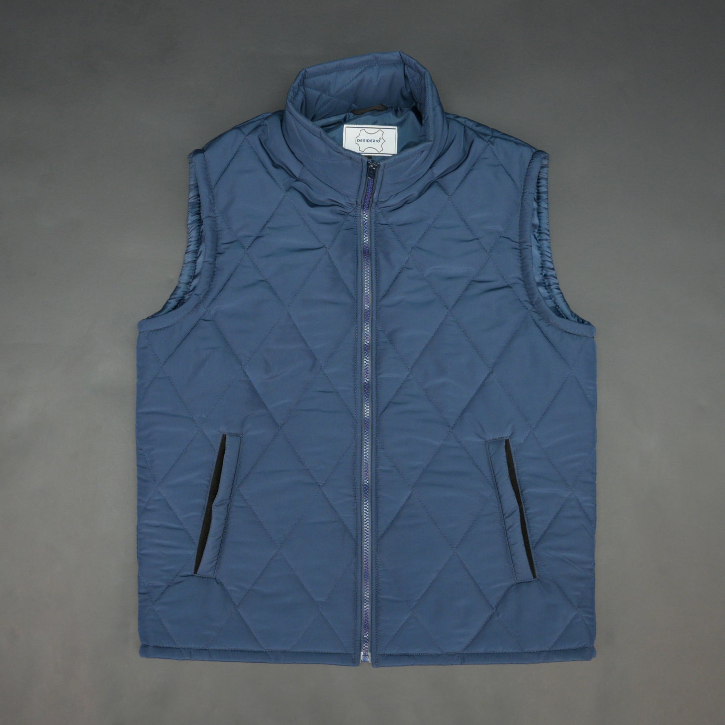 Blue sleeveless puffer vest with zip, side and inside pockets, lightweight for layering
