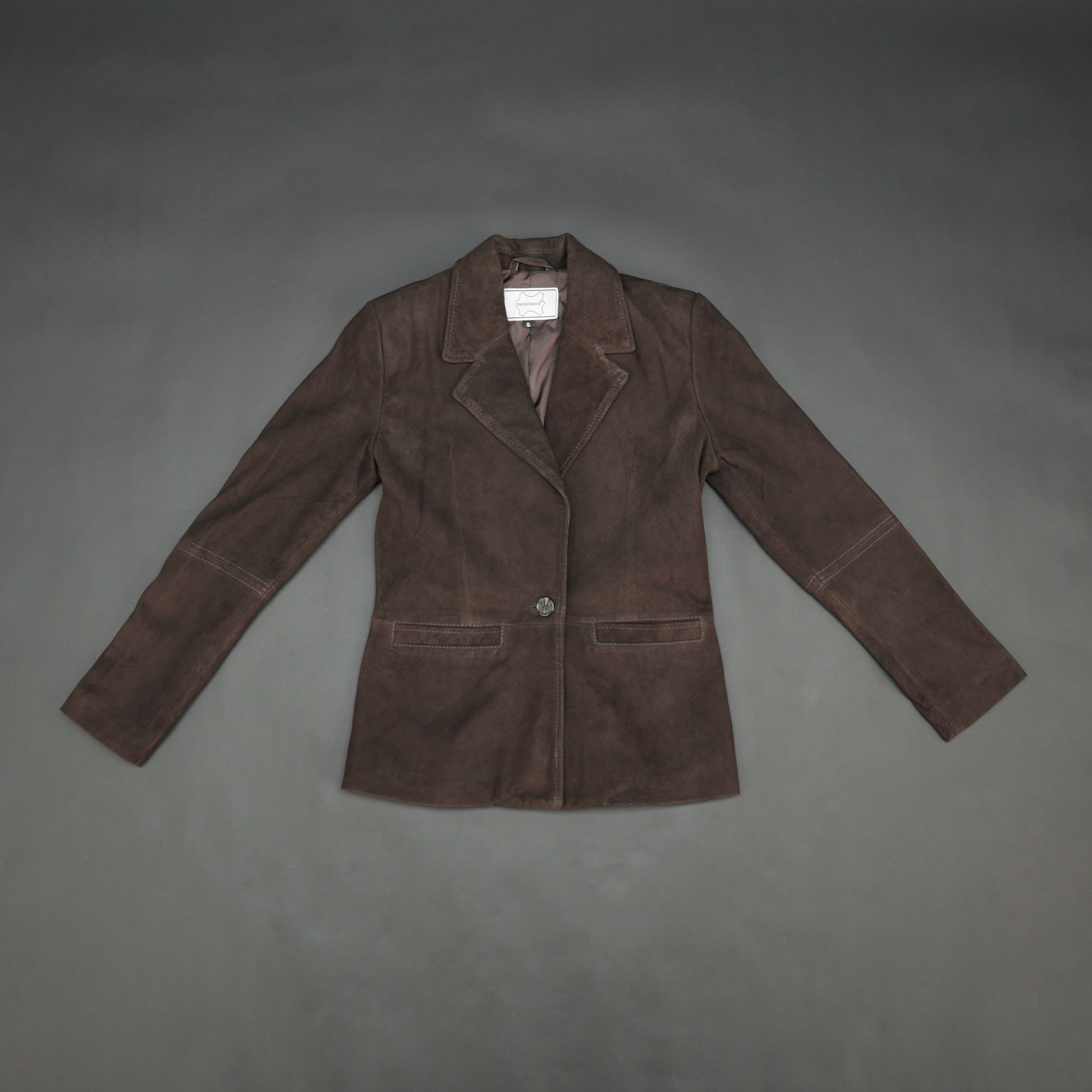 Dark brown goat leather coat with soft, durable material, two functional pockets, and versatile design for casual and formal wear