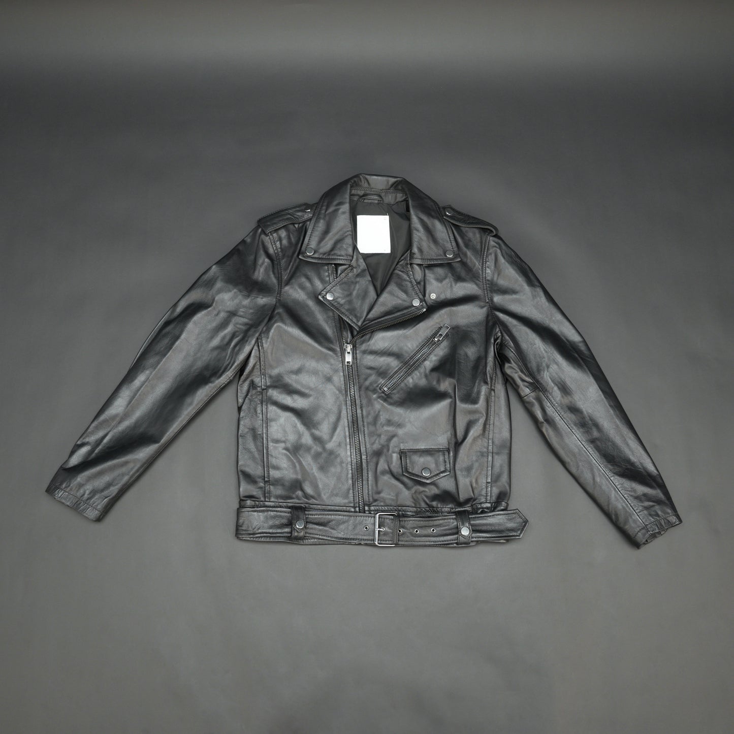 Black sheep leather jacket with adjustable waist belt, two front side pockets, one inside pocket, and zip flap closure