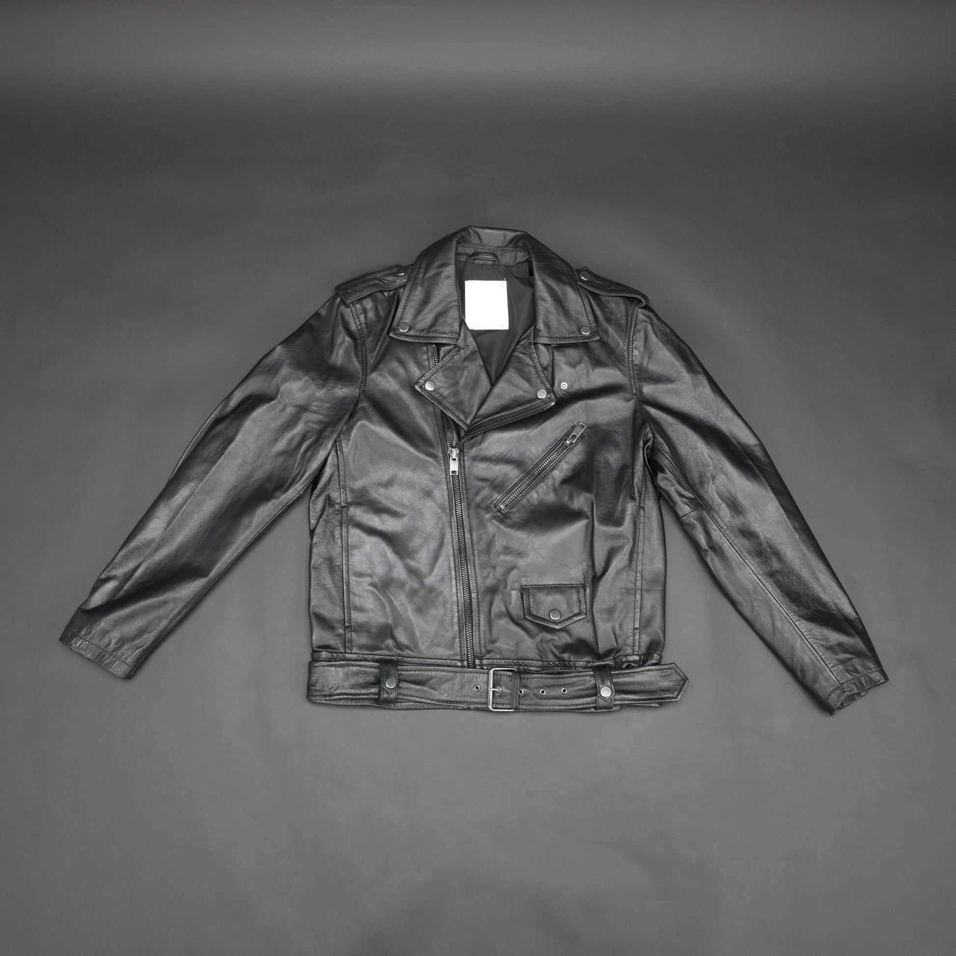 Black sheep leather jacket with adjustable waist belt, two front side pockets, one inside pocket, and zip flap closure