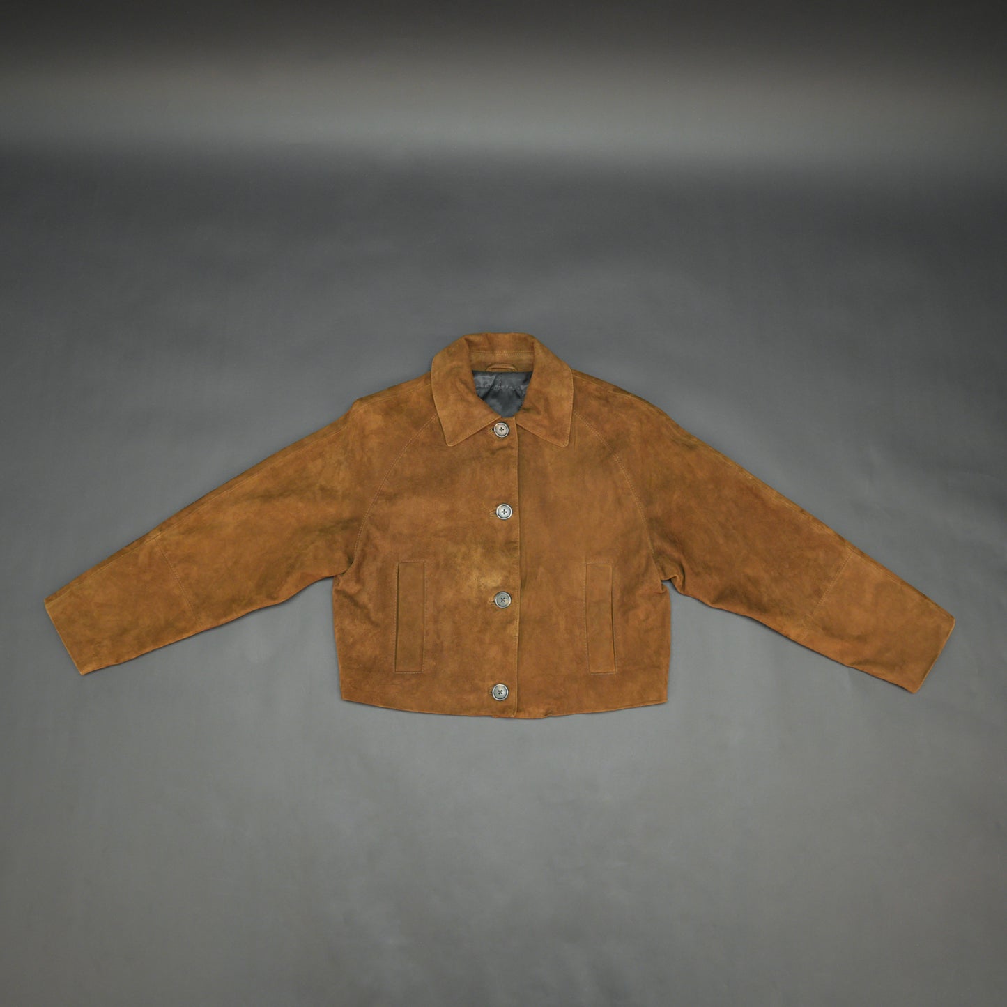 Brown suede leather jacket with button closure, slim fit, side pockets, and soft premium suede finish