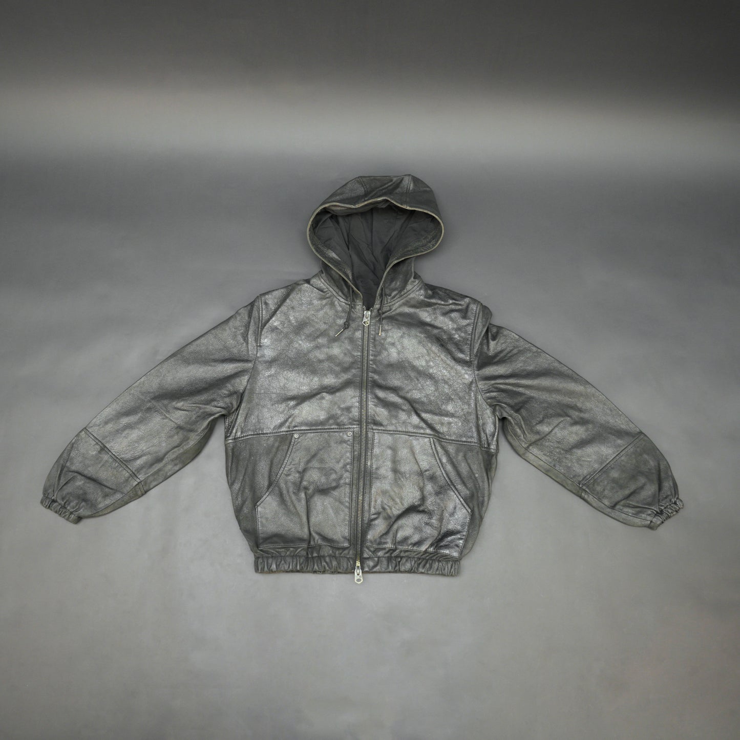 Black hoodie-style jacket made from genuine sheep leather (veg ranger), featuring a front zip closure, adjustable hood, two side pockets, and one inside pocket