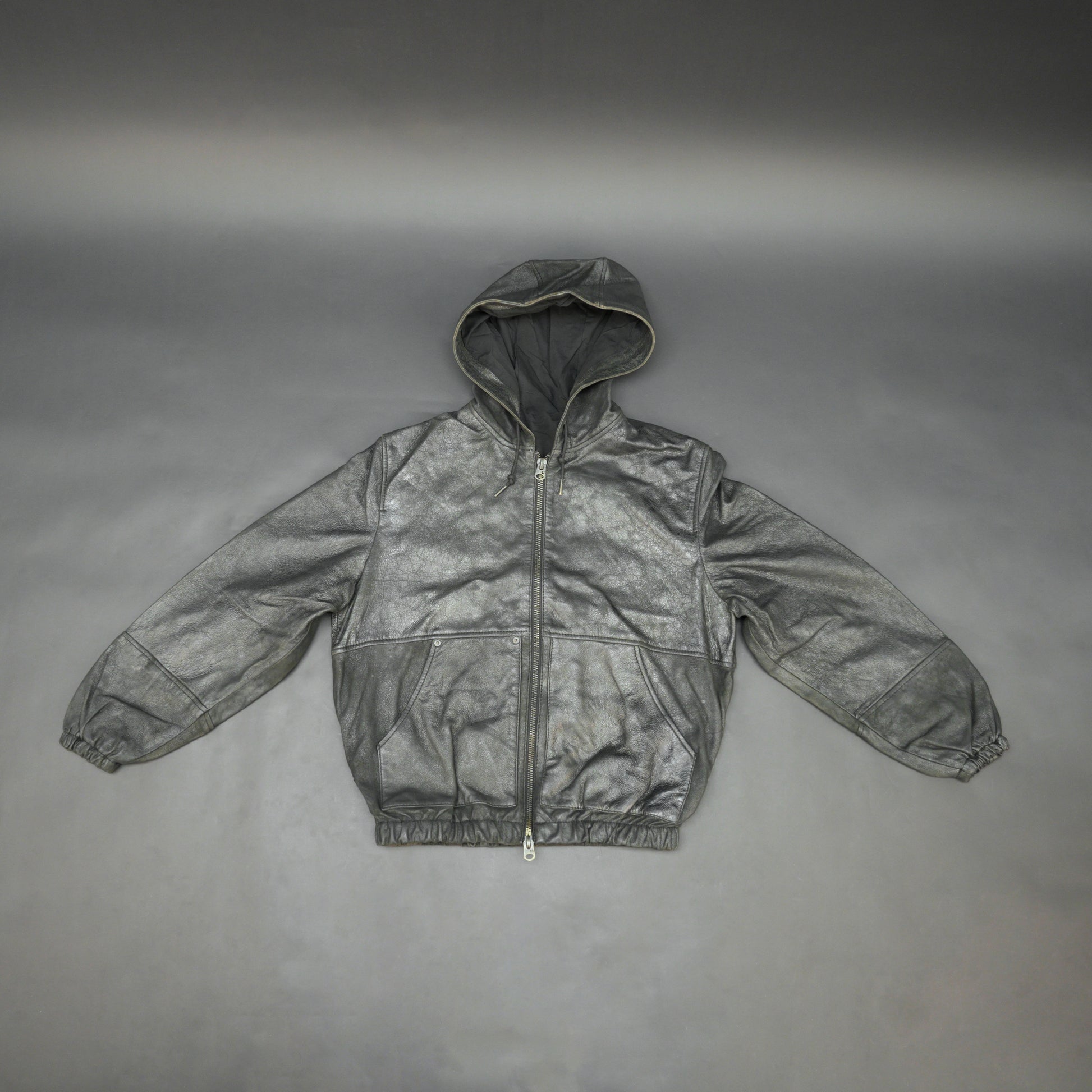 Black hoodie-style jacket made from genuine sheep leather (veg ranger), featuring a front zip closure, adjustable hood, two side pockets, and one inside pocket