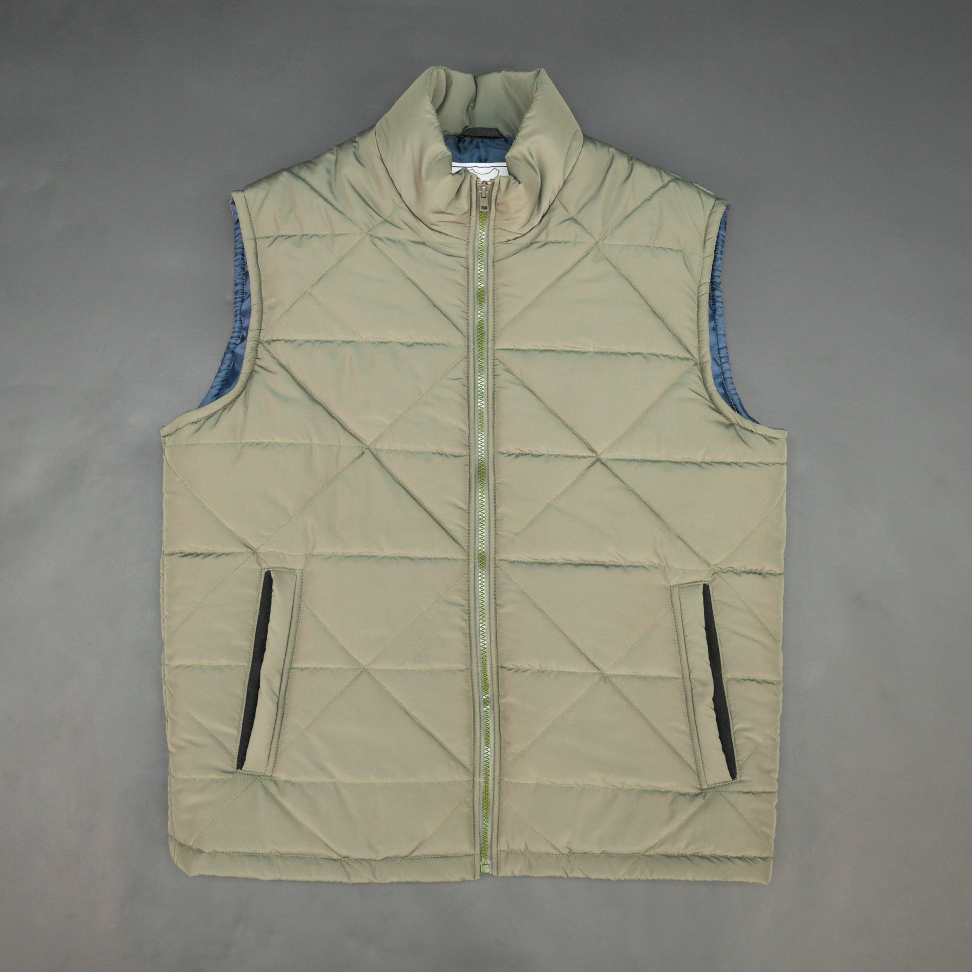 Green sleeveless puffer vest with zip closure, side and inner pockets, lightweight and ideal for layering.