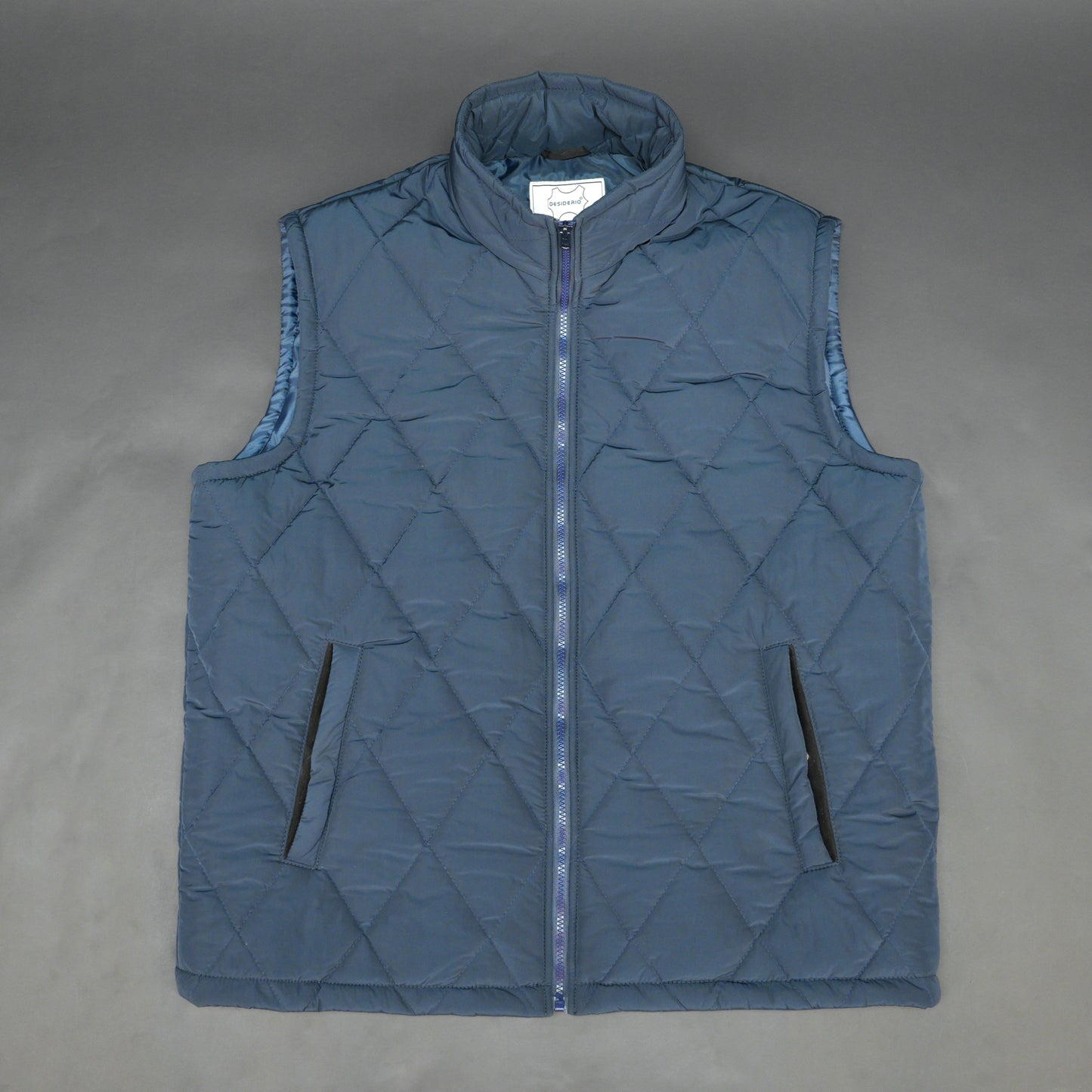 Navy sleeveless puffer vest with zip, side and inside pockets, lightweight for layering