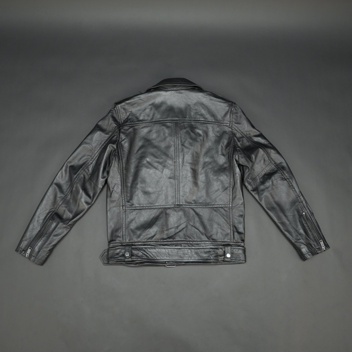 Black sheep leather jacket with adjustable waist belt, two front side pockets, one inside pocket, and zip flap closure