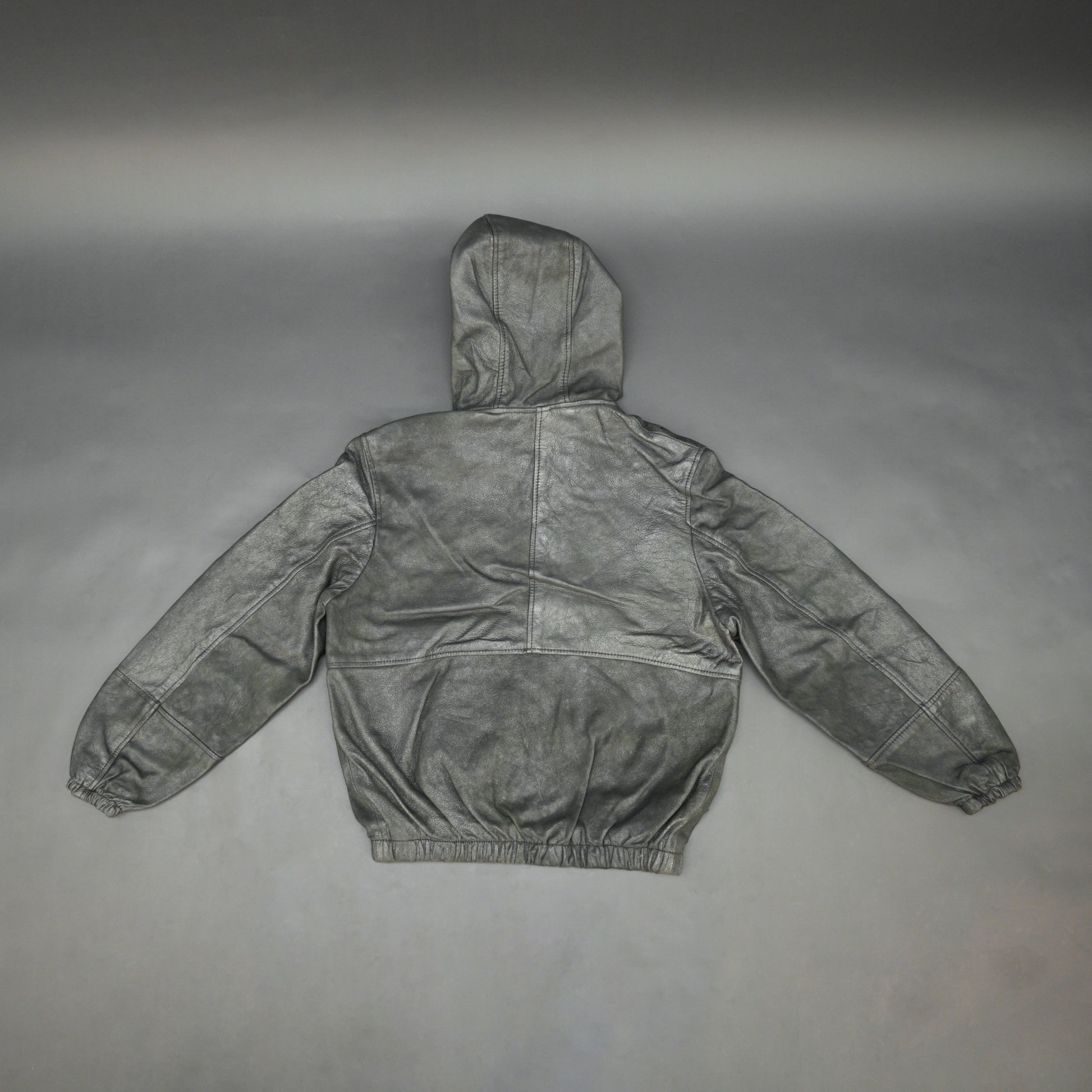 Black hoodie-style jacket made from genuine sheep leather (veg ranger), featuring a front zip closure, adjustable hood, two side pockets, and one inside pocket