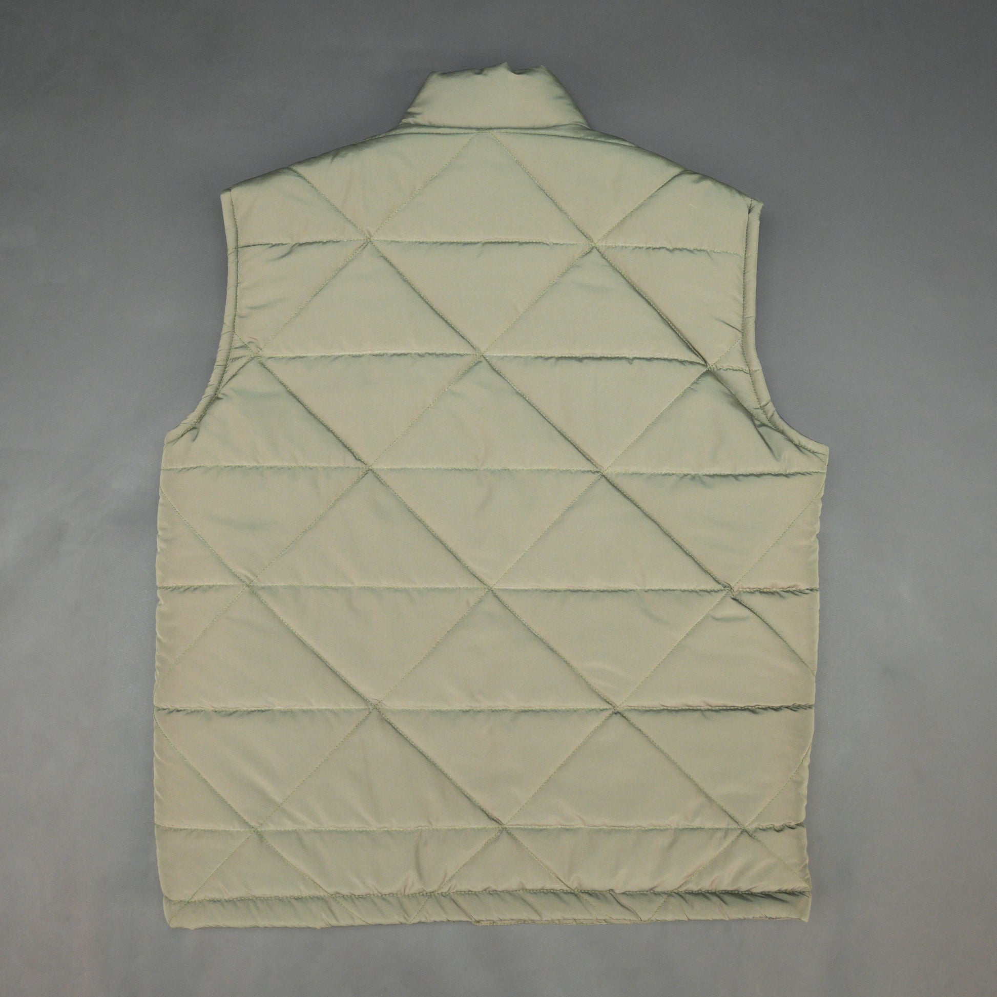 Green sleeveless puffer vest with zip closure, side and inner pockets, lightweight and ideal for layering.