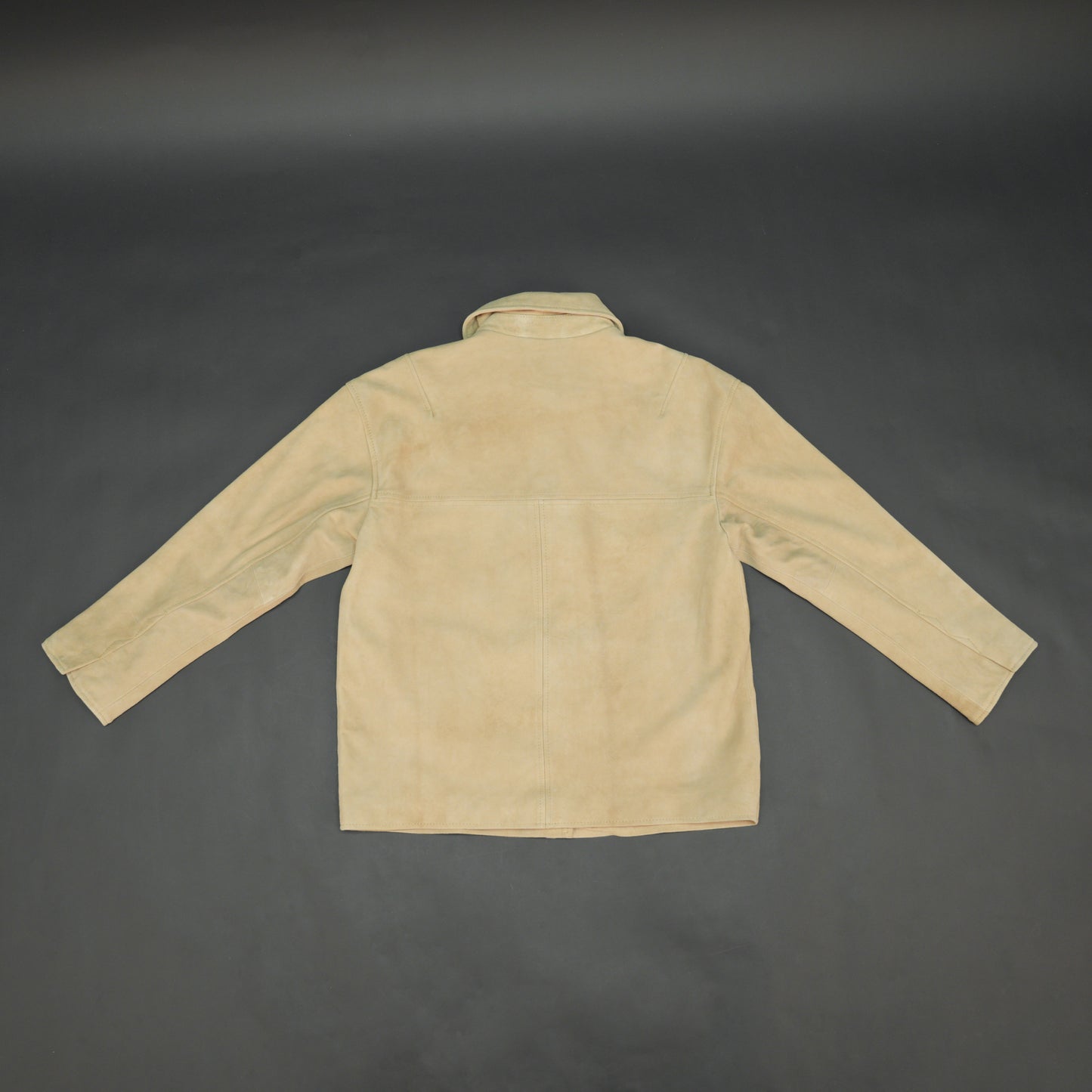 Beige suede leather jacket with tailored fit, elegant button opening, and front side pockets