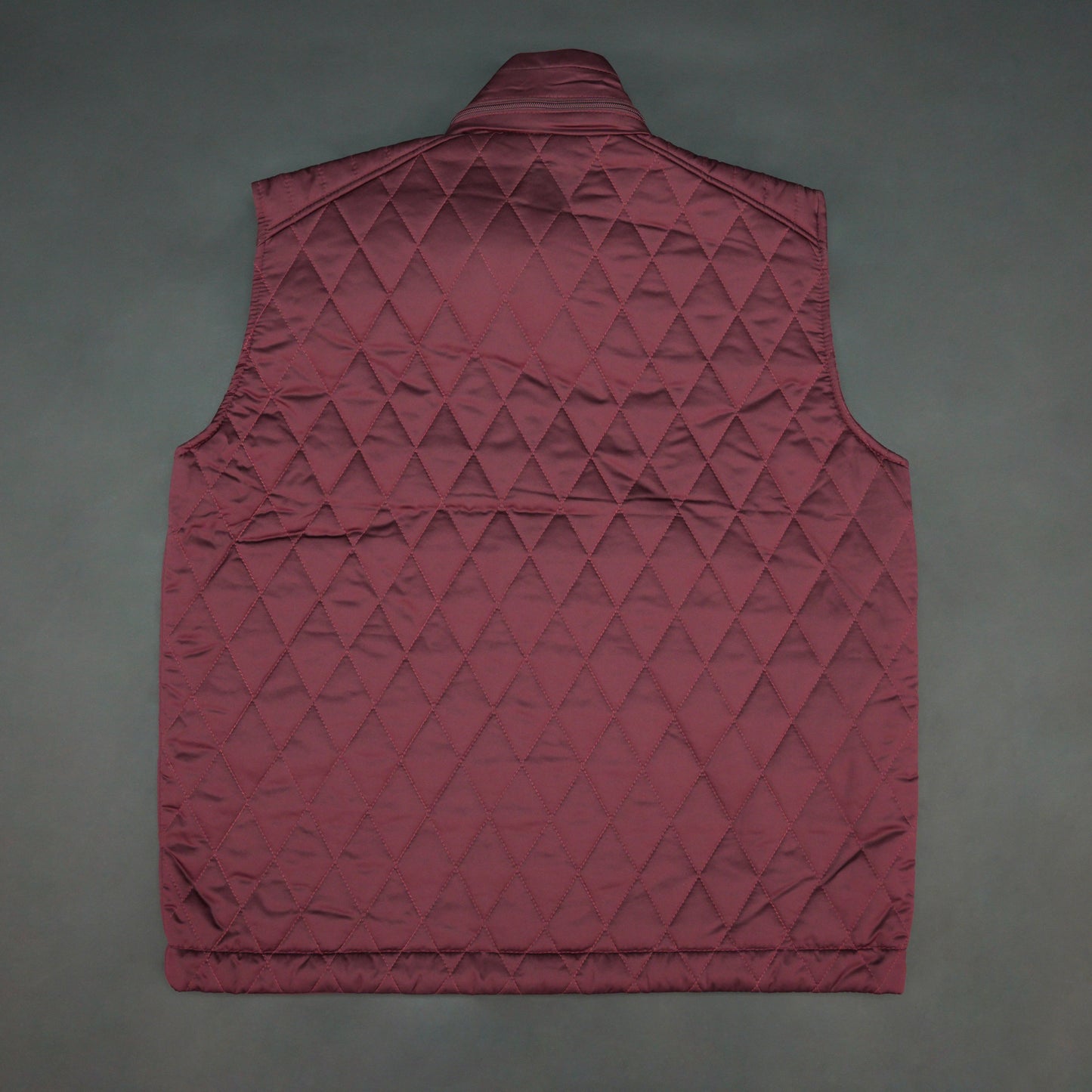 Maroon vest featuring a zip closure with snap button, two snap-button side pockets, and an inside pocket for secure, convenient storage