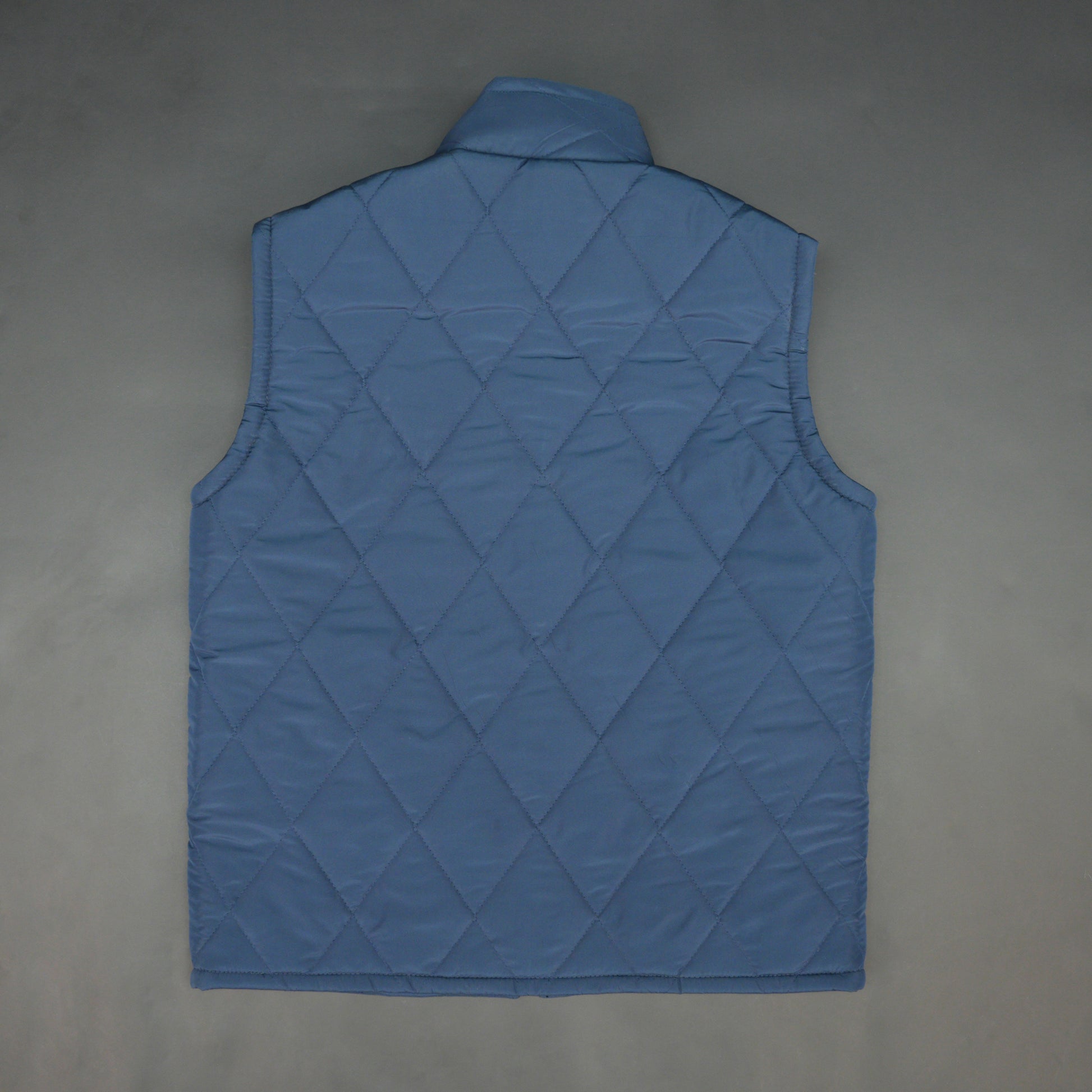 Blue sleeveless puffer vest with zip, side and inside pockets, lightweight for layering