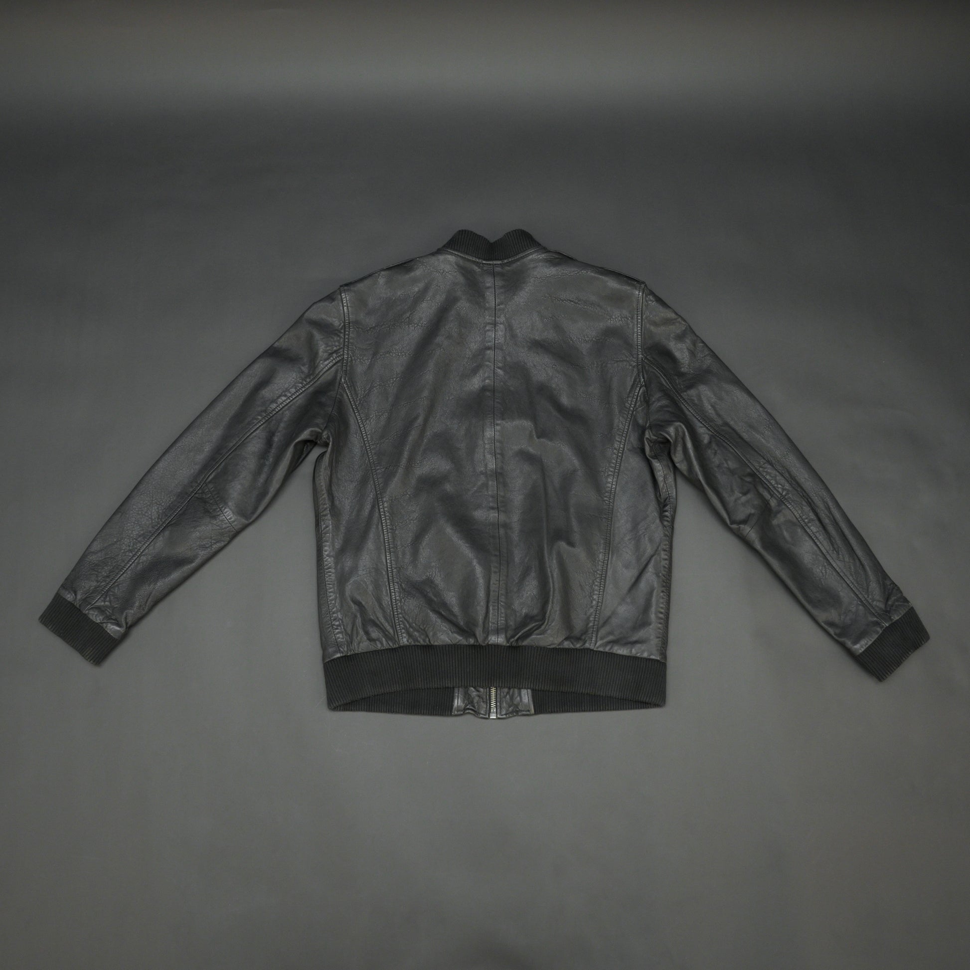 Black sheep leather jacket with soft material, front and inside pockets, and zip closure