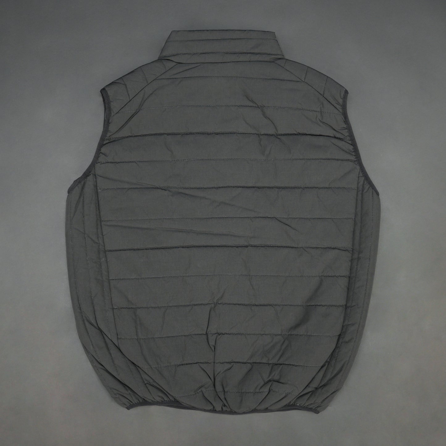 Black garment featuring a front zip closure, two snap-button side pockets, and two inside pockets for secure, convenient storage