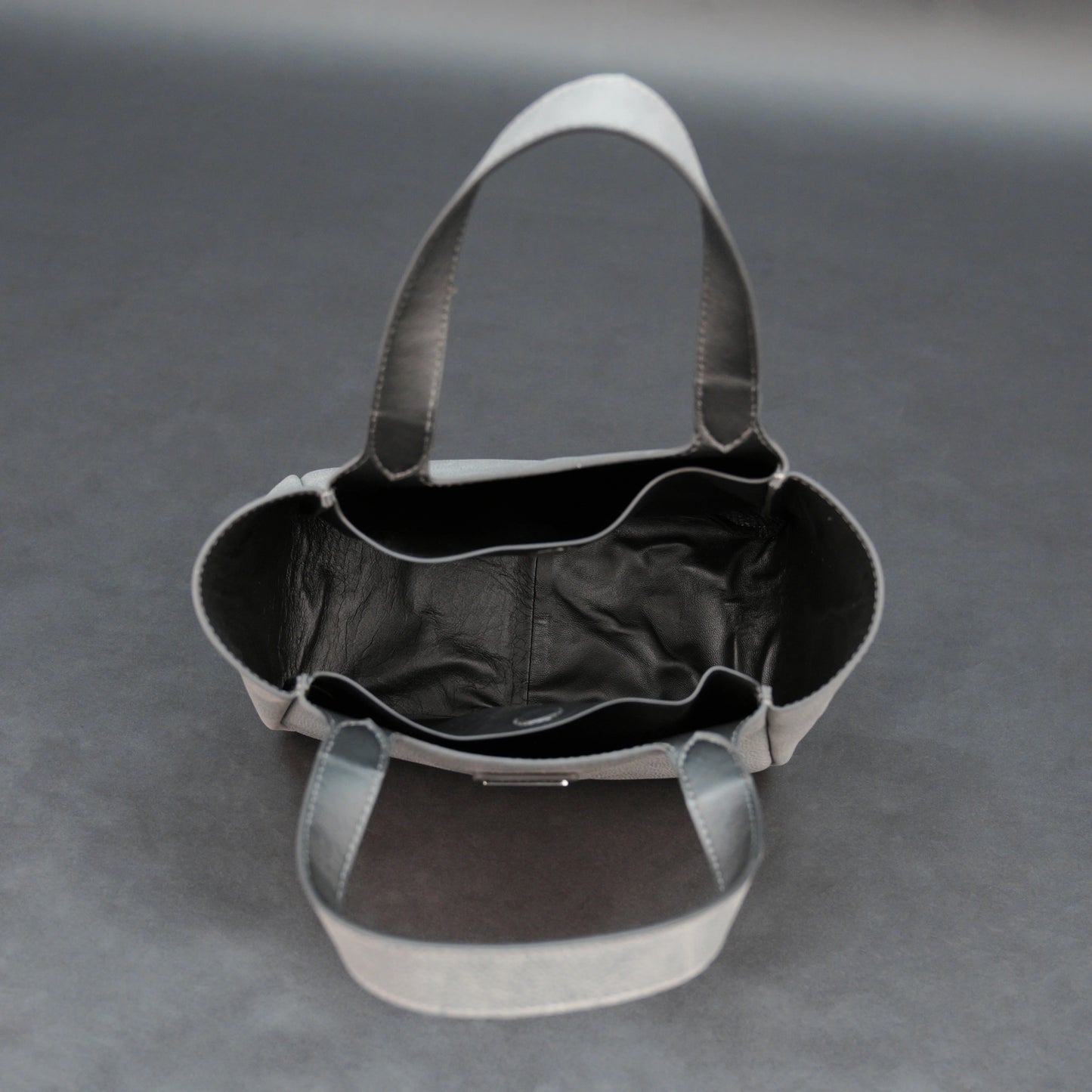 Premium grey cow vachetta leather bag with spacious compartment and inner pockets.