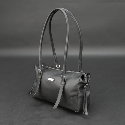 Black cow Chelsea leather bag with strap and pockets.
