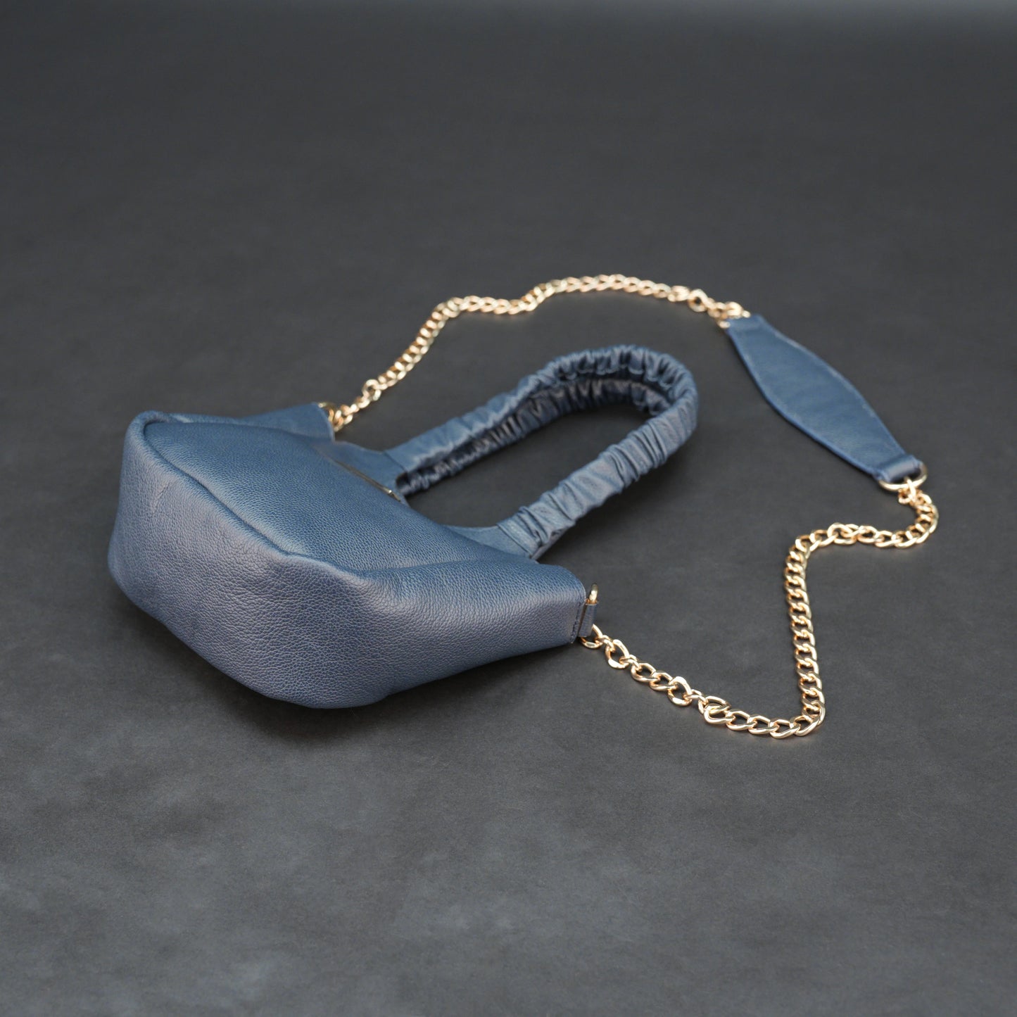 Deep blue premium cow leather bag with shoulder strap, main compartment, and inner pocket.
