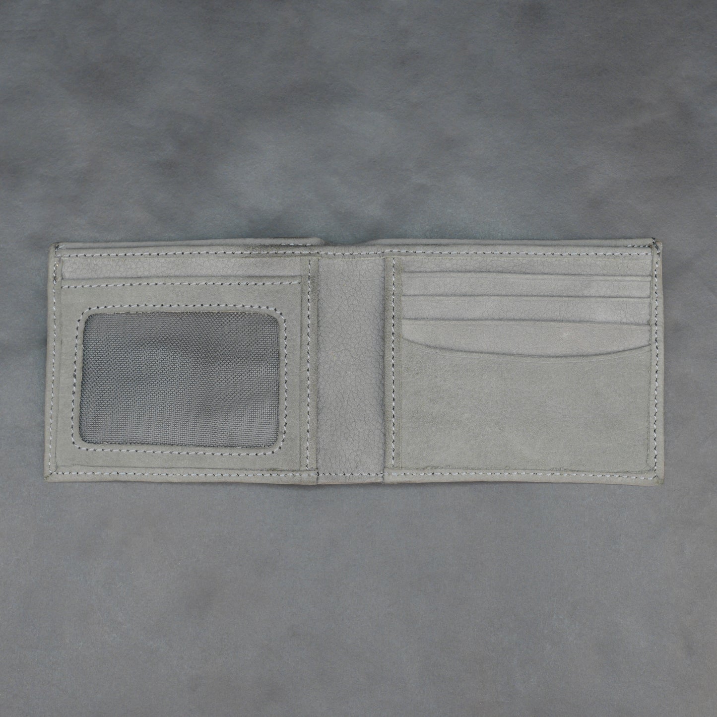 Grey leather wallet with 10 card slots and 2 cash compartments, sleek, slim, and durable for everyday use