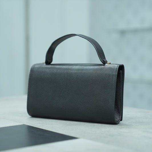 Black leather Grab Handle bag with a minimalist design, featuring a sturdy top handle and two open pockets, combining style and functionality for everyday use