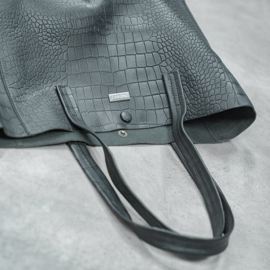 Stylish black shoulder bag with a spacious main compartment and ergonomic strap, offering comfort and functionality for work, errands, or casual outings