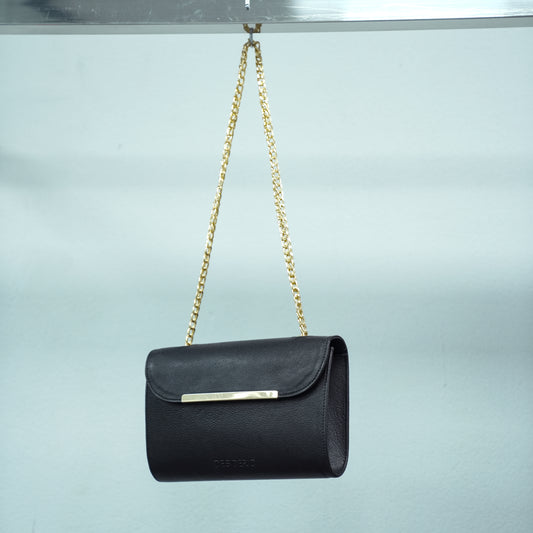 Black crossbody bag made of premium leather with long chain strap, two open pockets, and versatile design for casual and formal occasions