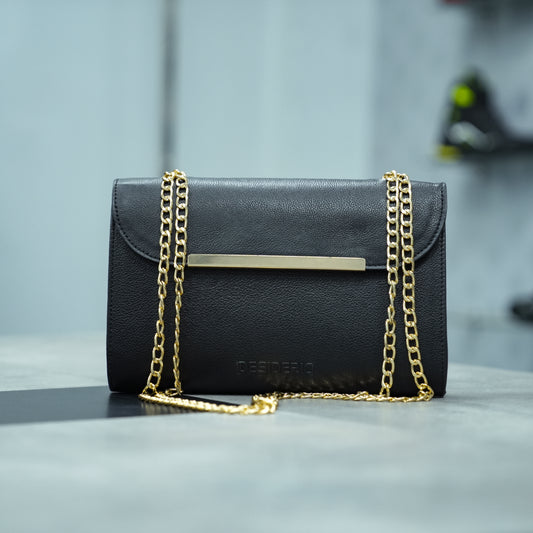 Black crossbody bag made of premium leather with long chain strap, two open pockets, and versatile design for casual and formal occasions