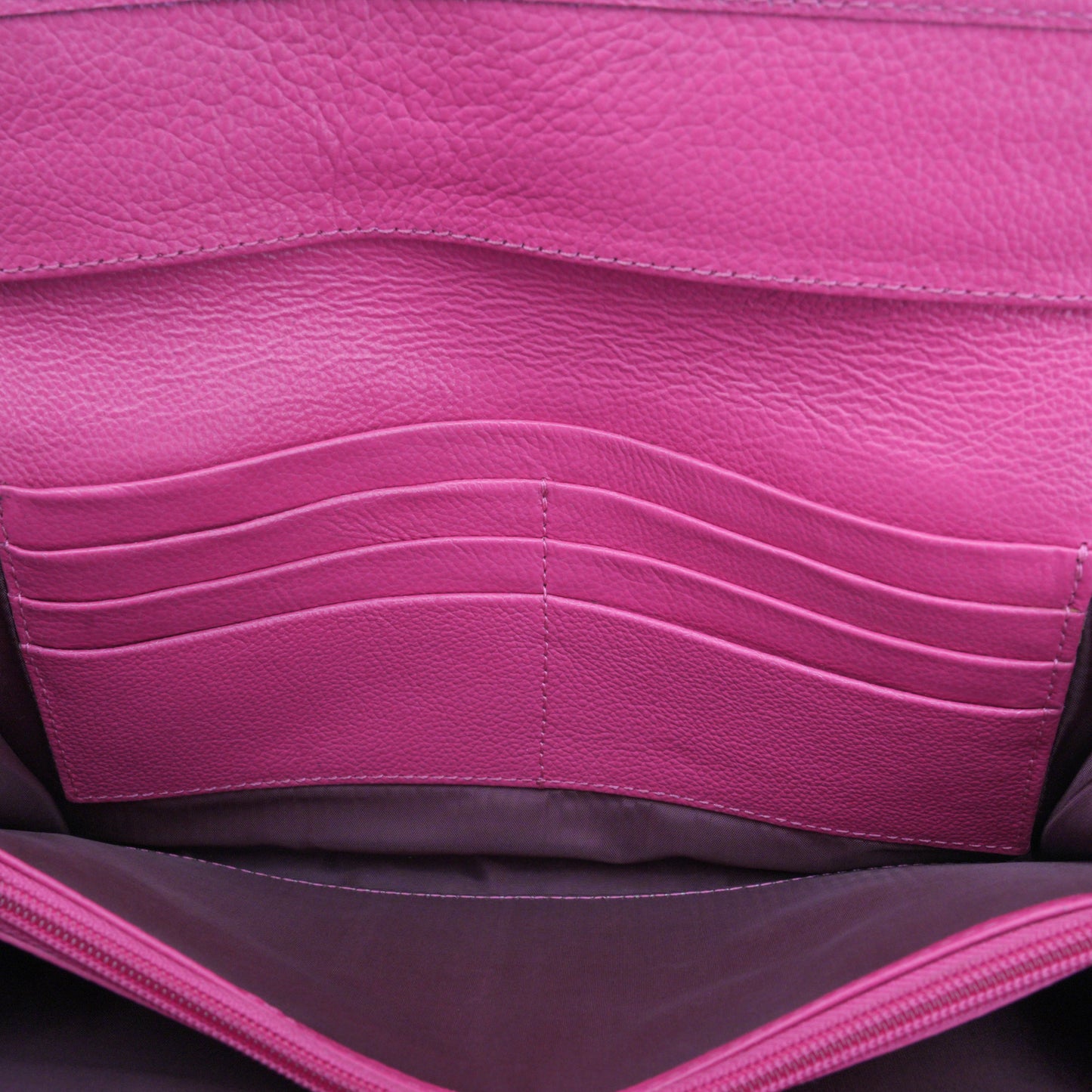 Stylish pink leather mini clutch with a compact and feminine design, including 3 organizing compartments, 16 card holders, and a secure zip pocket for coins or key