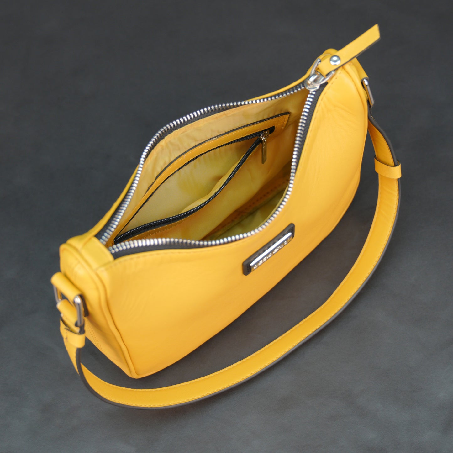 Yellow sheep leather bag with zip closure and inner pocket.