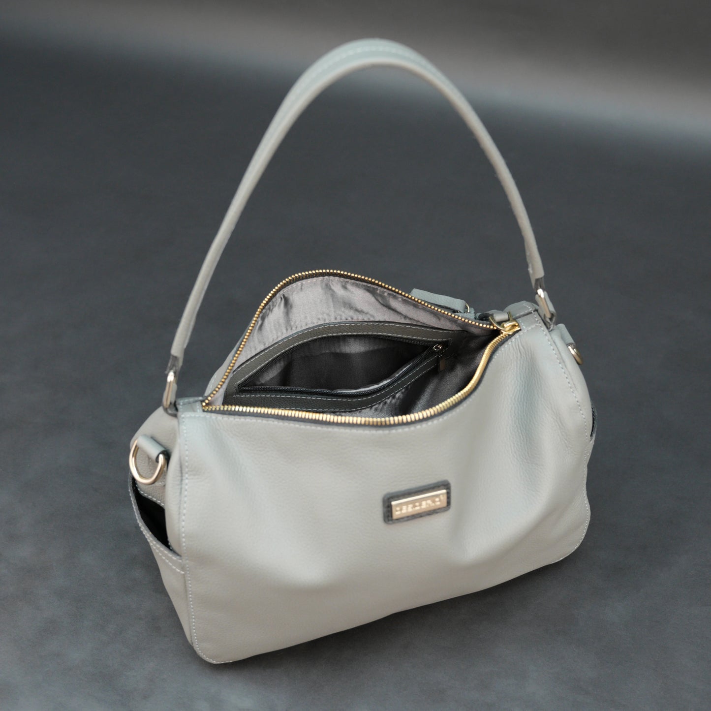 Silver cow Chelsea leather bag with zip closure, multiple pockets, and durable everyday design.