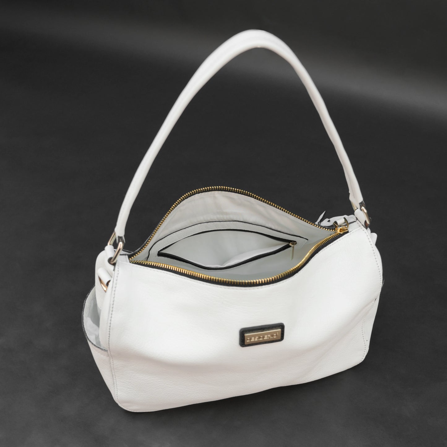 White goat leather bag with zip closure, multiple pockets, and durable everyday design.