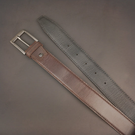 Premium leather belt with solid one-piece construction, charcoal metal buckle, durable, adjustable, stylish for jeans and dress wear