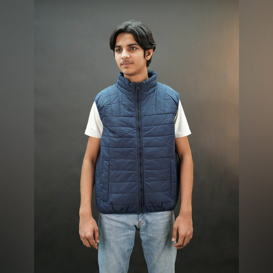 Teen lightweight puffer vest in blue and black with full front zip, two side snap pockets, and two inside pockets, warm and ideal for winter