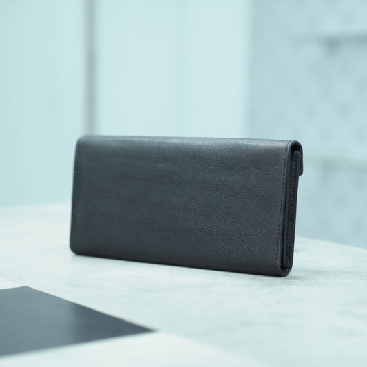 Black leather clutch with three main compartments, one zip pocket, and three card pockets for organized storage