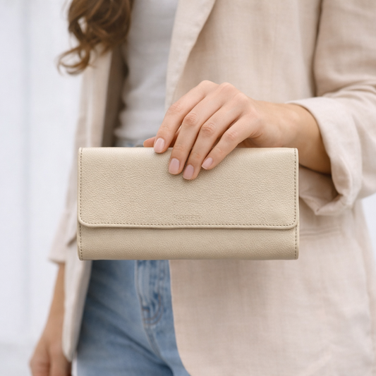 Beige leather clutch with two open pockets, one zip pocket, and eleven card slots