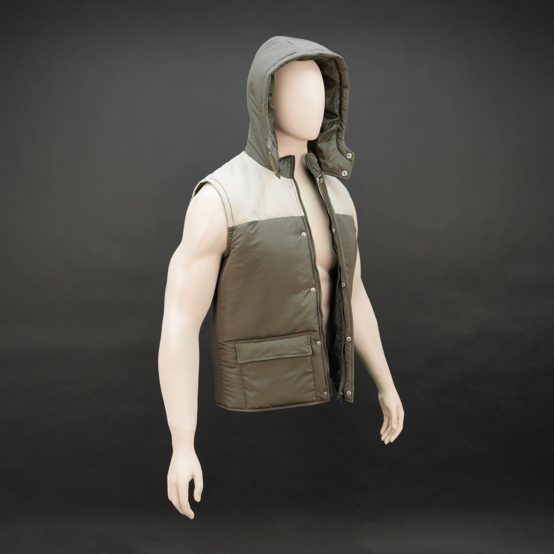 Green-cream sleeveless puffer jacket with zip and snap closure, hood, side and inner pockets, quilted for transitional seasons.