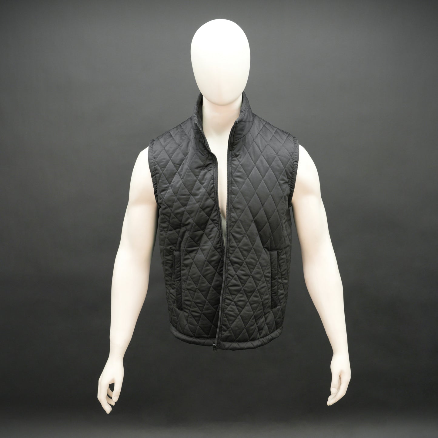 Lightweight black quilted sleeveless  puffer vest with zip closure, side and inside pockets, ideal for layering